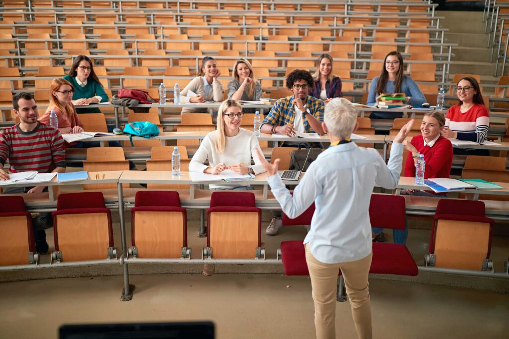 students in college class listening to professor speak