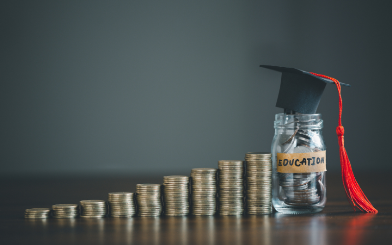 a declining stack of coins next to a jar of coins labeled education with a graduation cap